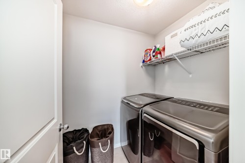 Dedicated laundry area featuring a wire shelf for storage, and light-colored walls - 2329 82 Street, Edmonton, AB - Indoor Photo Showing Laundry Room