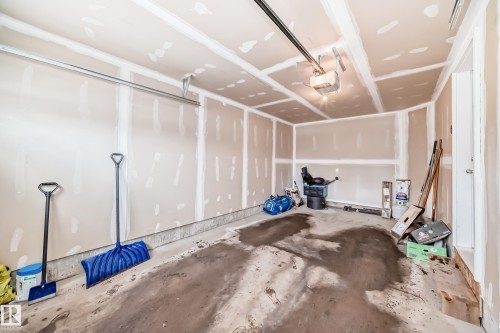 The property includes an unfinished garage with a concrete floor and an overhead garage door opener - 2329 82 Street, Edmonton, AB - Indoor