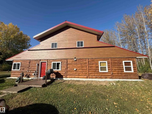 Expansive log-style siding exterior with a red pitched roof - 63218 Range Road 254, Rural Westlock County, AB 