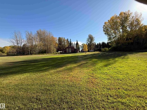 Expansive green lawn with a distant residence visible - 63218 Range Road 254, Rural Westlock County, AB 
