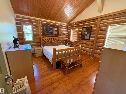 Log construction interior featuring exposed wood beams - 63218 Range Road 254, Rural Westlock County, AB 