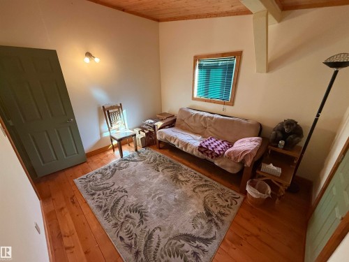 Interior room featuring wood-finish flooring, a wood plank ceiling, and a light-toned wall finish - 63218 Range Road 254, Rural Westlock County, AB 