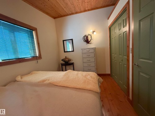 Interior room featuring a wood-finish vaulted ceiling and wood-finish flooring - 63218 Range Road 254, Rural Westlock County, AB 
