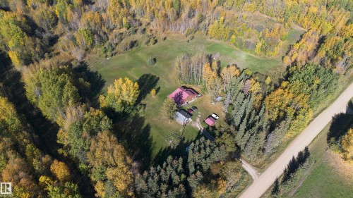 Aerial perspective showcasing a property surrounded by mature trees, including both deciduous and coniferous varieties - 63218 Range Road 254, Rural Westlock County, AB 