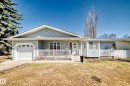 Light blue vinyl siding exterior with an attached garage, covered front porch, and a white paneled front door - 17 Springfield Crescent, St. Albert, AB  - Outdoor With Deck Patio Veranda 