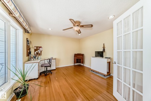 Room featuring wood-finish flooring, recessed lighting, and a ceiling fan - 17 Springfield Crescent, St. Albert, AB - Indoor Photo Showing Other Room