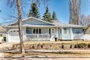Light blue siding exterior featuring a covered front porch with white railings, an attached single-car garage, and a bay window - 17 Springfield Crescent, St. Albert, AB  - Outdoor With Deck Patio Veranda 