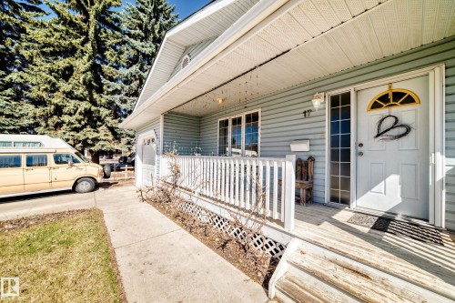 Front entry porch featuring light blue siding and white trim - 17 Springfield Crescent, St. Albert, AB - Outdoor