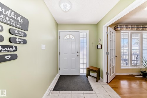 Entryway featuring a white paneled door with an arched transom window and a frosted glass sidelight - 17 Springfield Crescent, St. Albert, AB - Indoor Photo Showing Other Room