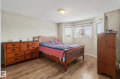Room featuring wood-finish flooring, a neutral wall color, and a ceiling-mounted light fixture - 11633 167B Avenue, Edmonton, AB - Indoor Photo Showing Bedroom