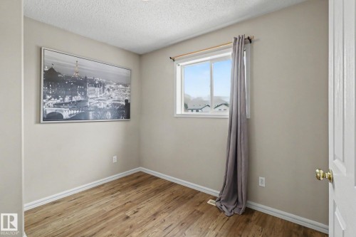Room with wood-finish flooring, neutral wall color, and white trim - 11633 167B Avenue, Edmonton, AB - Indoor Photo Showing Other Room