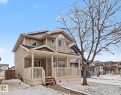 Two-story residence featuring light-colored siding and a covered front porch with white railings - 11633 167B Avenue, Edmonton, AB  - Outdoor With Deck Patio Veranda With Facade 