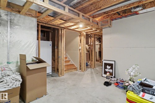 Unfinished basement space featuring visible wood framing, a concrete floor, and exposed ceiling joists - 11633 167B Avenue, Edmonton, AB - Indoor Photo Showing Basement