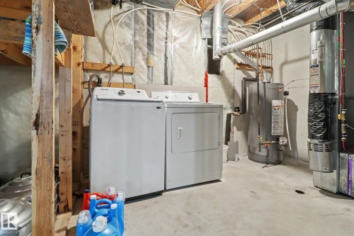 Dedicated laundry area featuring a white washing machine and dryer - 11633 167B Avenue, Edmonton, AB - Indoor Photo Showing Laundry Room