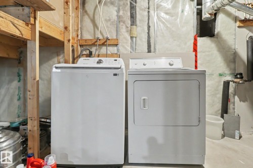 Dedicated laundry area featuring a white top-load washing machine and a white electric dryer - 11633 167B Avenue, Edmonton, AB - Indoor Photo Showing Laundry Room