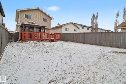 Spacious backyard featuring a multi-level wood deck with privacy lattice, a built-in gazebo, and a full privacy fence - 11633 167B Avenue, Edmonton, AB - Outdoor With Deck Patio Veranda