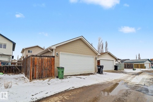 Detached garage with horizontal siding, a pitched roof, and a white overhead door - 11633 167B Avenue, Edmonton, AB - Outdoor