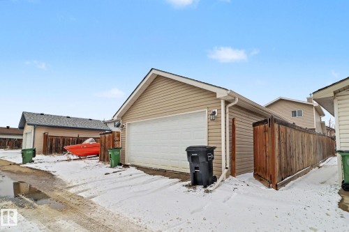Detached garage with horizontal siding and a white overhead door - 11633 167B Avenue, Edmonton, AB - Outdoor With Exterior