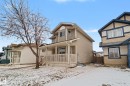 Two-story property featuring light beige siding, a covered front porch with white railings, and a peaked roofline - 11633 167B Avenue, Edmonton, AB  - Outdoor With Deck Patio Veranda 
