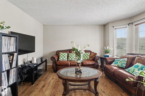Living area featuring wood-finish flooring, light-toned walls, and a textured ceiling - 11633 167B Avenue, Edmonton, AB - Indoor Photo Showing Living Room