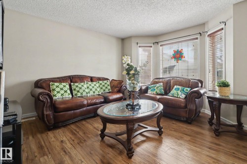 Living area featuring wood-finish flooring, a neutral wall palette, and textured ceiling - 11633 167B Avenue, Edmonton, AB - Indoor Photo Showing Living Room
