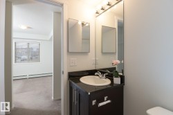 Vanity featuring a dark countertop, white oval sink, and chrome fixtures - 