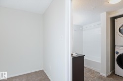 Bathroom featuring a white tub, shower with a white surround, and a dark brown vanity with a white basin sink - 