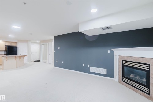 204 1320 Rutherford Road, Edmonton, AB - Indoor Photo Showing Living Room With Fireplace