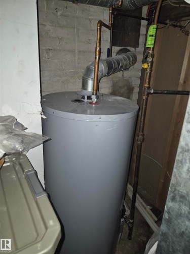 Water heater with copper piping and galvanized ductwork - 11301 87 Street, Edmonton, AB - Indoor Photo Showing Basement