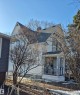 White two-story residence featuring a covered front porch (3.12x2.26) with decorative railings - 11301 87 Street, Edmonton, AB  - Outdoor 