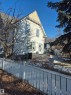 Two-story property featuring white siding and a gable roof with yellow shingle detailing and back deck (3.50x3.50) - 11301 87 Street, Edmonton, AB  - Outdoor 