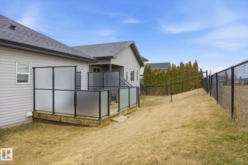 Rear deck featuring frosted panel railings and dark wood-finish decking - 28 Hewitt Circle, Spruce Grove, AB - Outdoor With Exterior