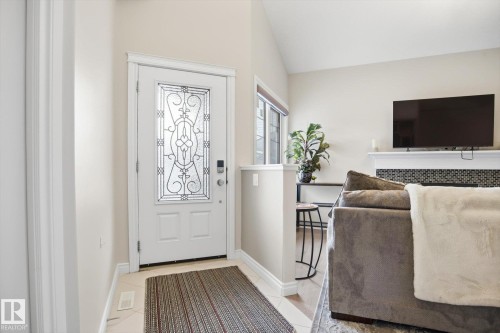 Entryway featuring a white door with decorative glass inserts - 28 Hewitt Circle, Spruce Grove, AB - Indoor Photo Showing Other Room