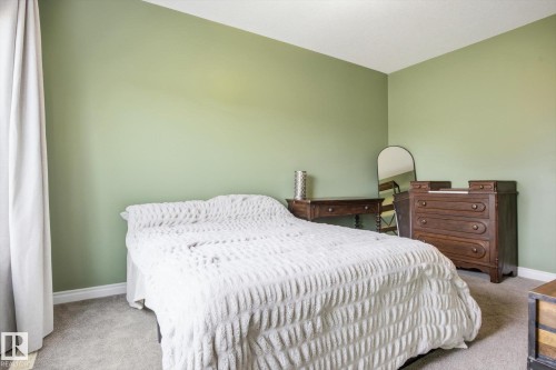 Room featuring neutral green walls, soft grey carpeting, white baseboards, and a white ceiling - 28 Hewitt Circle, Spruce Grove, AB - Indoor Photo Showing Bedroom