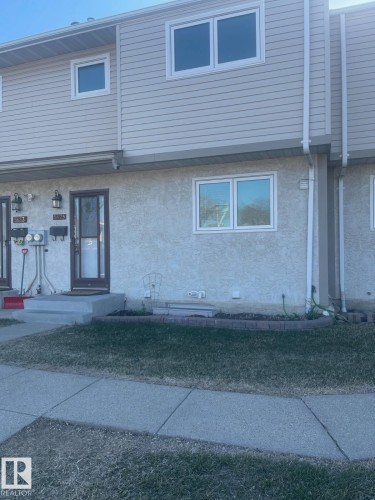 Two-story townhome featuring light-colored siding and stucco exterior - 5625 137 Avenue, Edmonton, AB - Outdoor