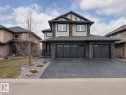 Two-story home featuring a combination of stone veneer and horizontal siding, a dark asphalt shingle roof, and a textured driveway - 1606 Adamson Close, Edmonton, AB  - Outdoor With Facade 