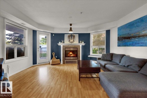 103 9008 99 Avenue, Edmonton, AB - Indoor Photo Showing Living Room With Fireplace