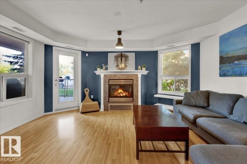103 9008 99 Avenue, Edmonton, AB - Indoor Photo Showing Living Room With Fireplace