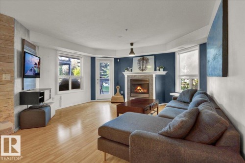 103 9008 99 Avenue, Edmonton, AB - Indoor Photo Showing Living Room With Fireplace