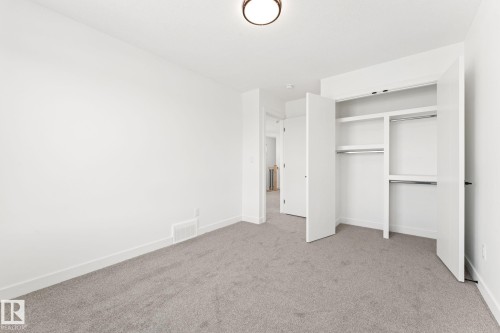 This room features light grey carpet flooring and white walls - 94 Blackbird Bend, Fort Saskatchewan, AB - Indoor Photo Showing Other Room