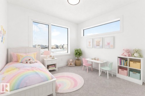 This room features light-colored carpeting, a large window, and a horizontal window - 94 Blackbird Bend, Fort Saskatchewan, AB - Indoor Photo Showing Bedroom