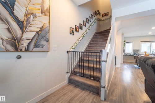 Carpeted staircase with white risers and handrails - 117 804 Welsh Drive, Edmonton, AB - Indoor Photo Showing Other Room