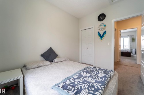 Bedroom featuring neutral wall paint, white trim, and light grey carpet flooring - 117 804 Welsh Drive, Edmonton, AB - Indoor Photo Showing Bedroom