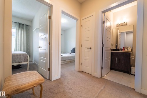 Hallway featuring carpet flooring and multiple paneled interior doors - 117 804 Welsh Drive, Edmonton, AB - Indoor Photo Showing Other Room