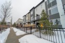 Modern multi-story facade featuring a striking two-tone exterior with dark gray and light siding - 117 804 Welsh Drive, Edmonton, AB  - Outdoor 