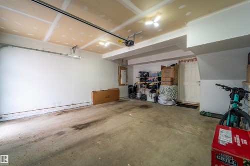Spacious garage with concrete flooring and exposed ceiling joists - 117 804 Welsh Drive, Edmonton, AB - Indoor