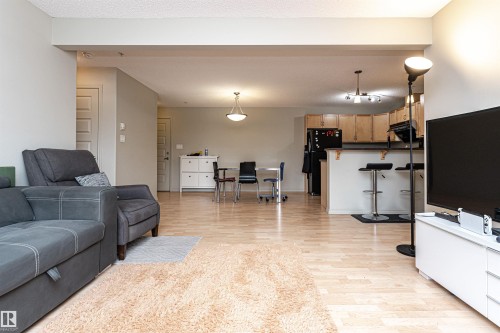 Open-concept living area featuring blonde wood-finish flooring throughout - 219 646 Mcallister Loop, Edmonton, AB - Indoor Photo Showing Living Room