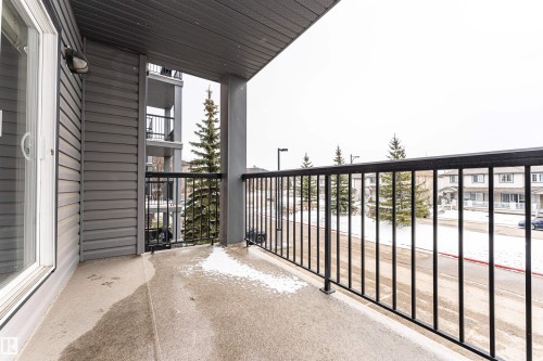 Private balcony featuring a concrete surface and black metal railings - 219 646 Mcallister Loop, Edmonton, AB - Outdoor With Balcony With Exterior