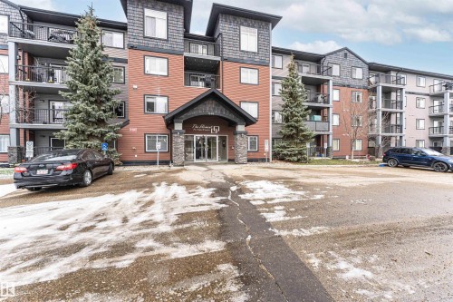 Multi-story residential building featuring a stone and siding exterior - 219 646 Mcallister Loop, Edmonton, AB - Outdoor With Balcony With Facade