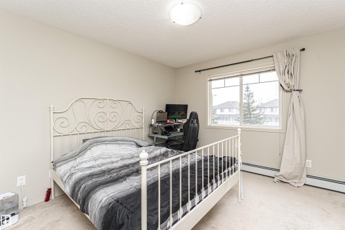 Carpeted room with a ceiling-mounted light fixture - 219 646 Mcallister Loop, Edmonton, AB - Indoor Photo Showing Bedroom